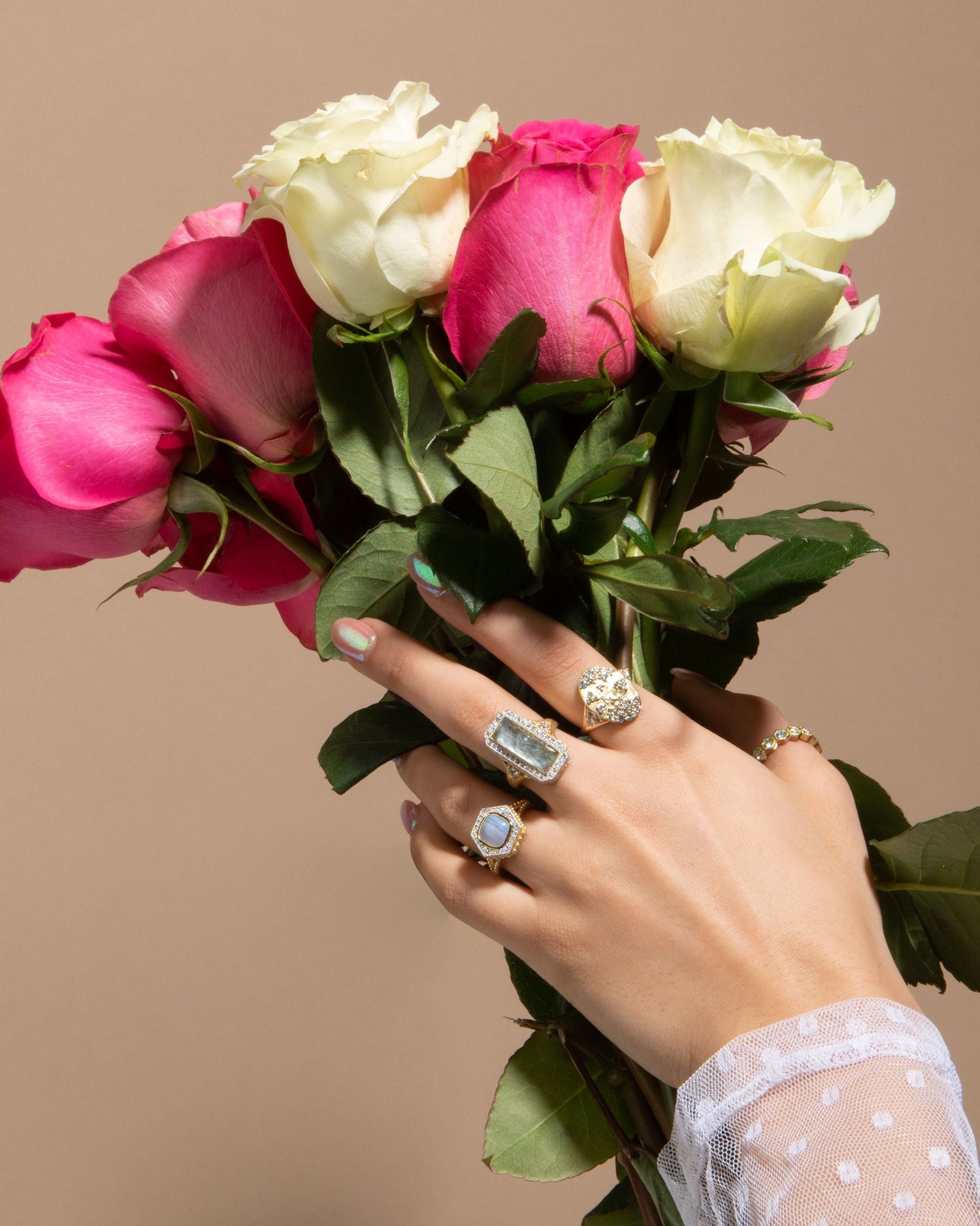 woman holding flowers with rings on her fingers