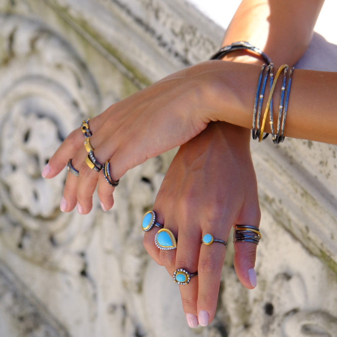 person with rings and bracelets on hands