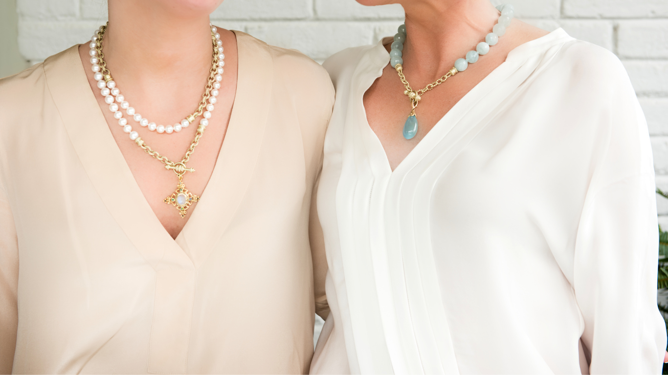 two women wearing thick necklaces around their neck