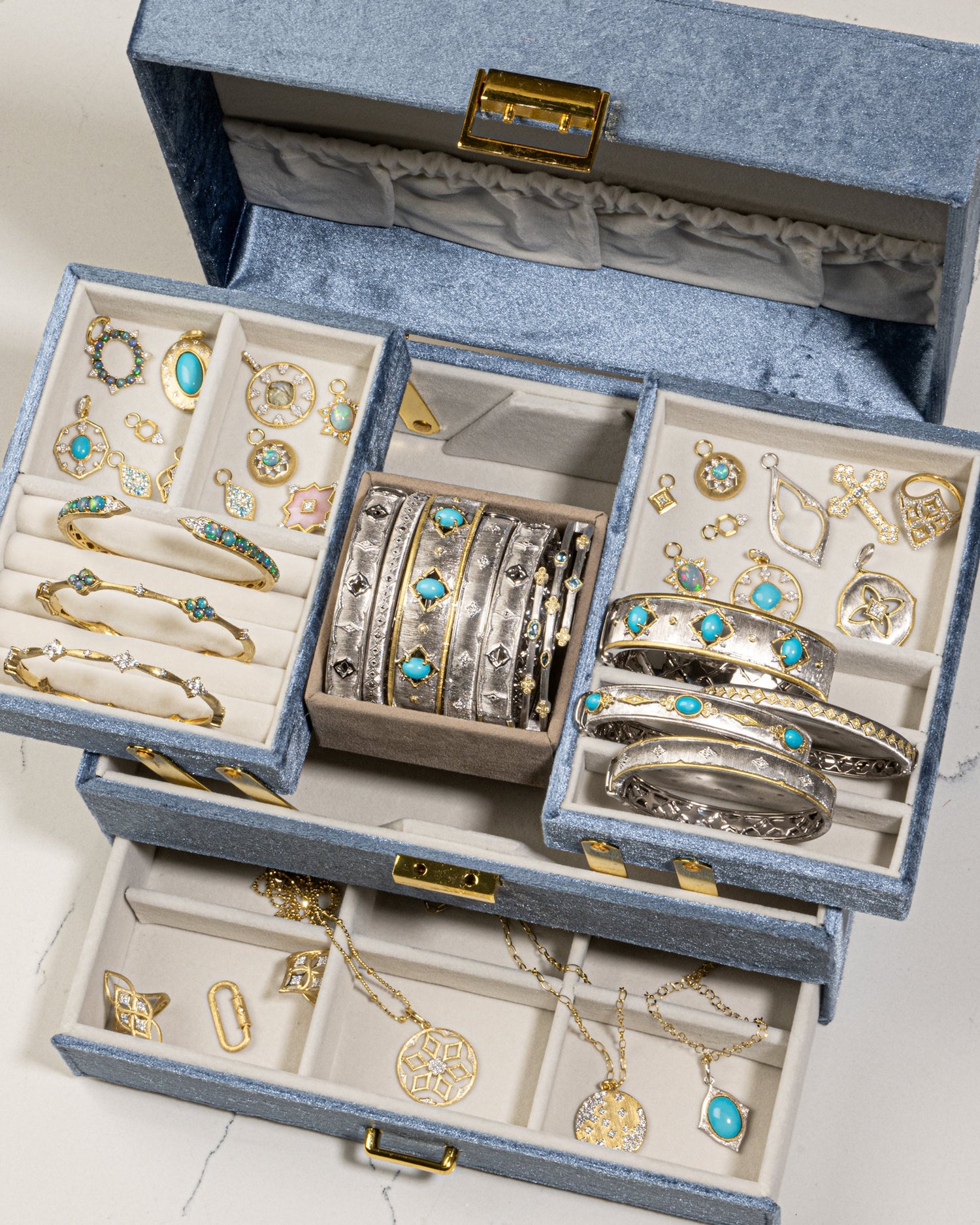 blue jewelry box with different jewelry pieces