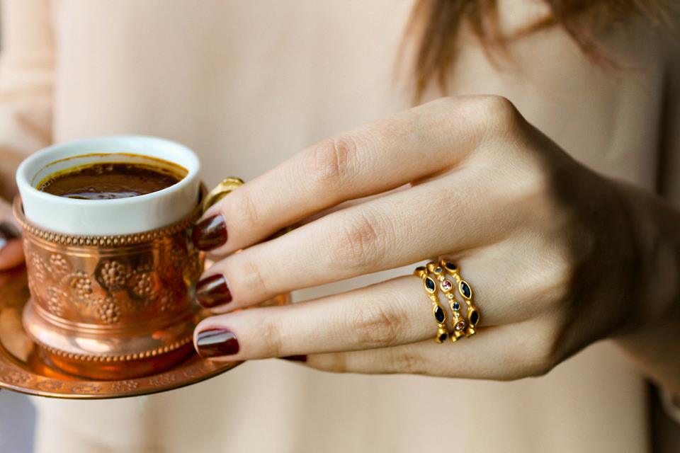 rings stacked on my model hand with coffee