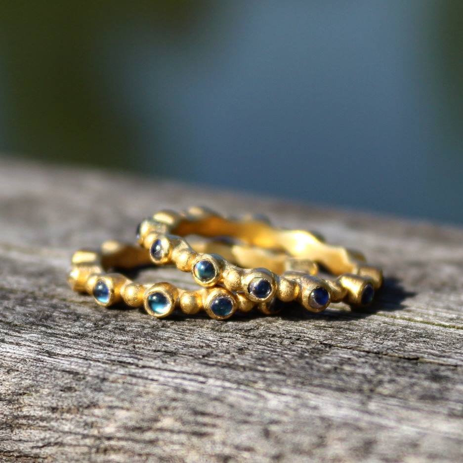 two gold rings stacked on top of each other