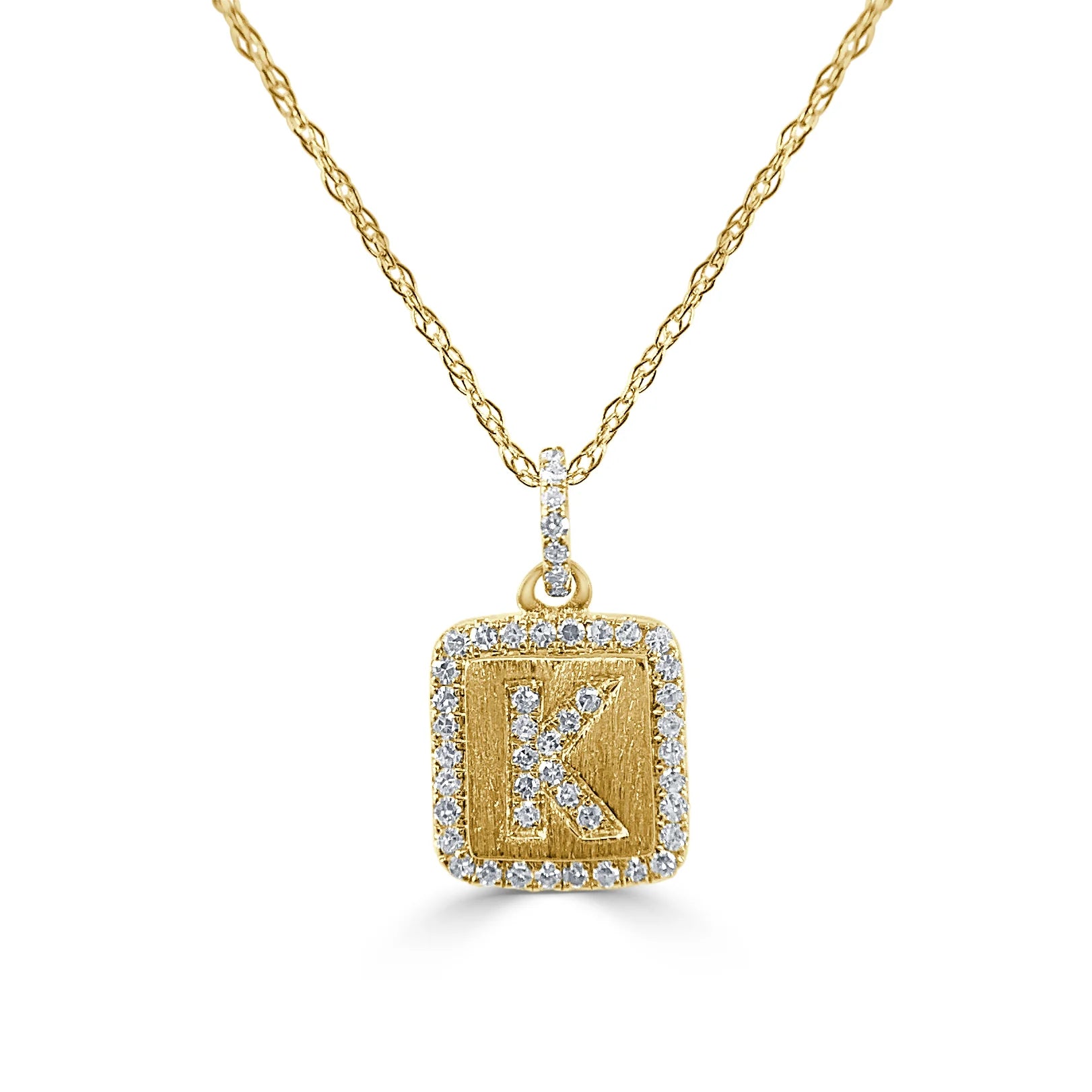 gold and diamond pendant with a letter K