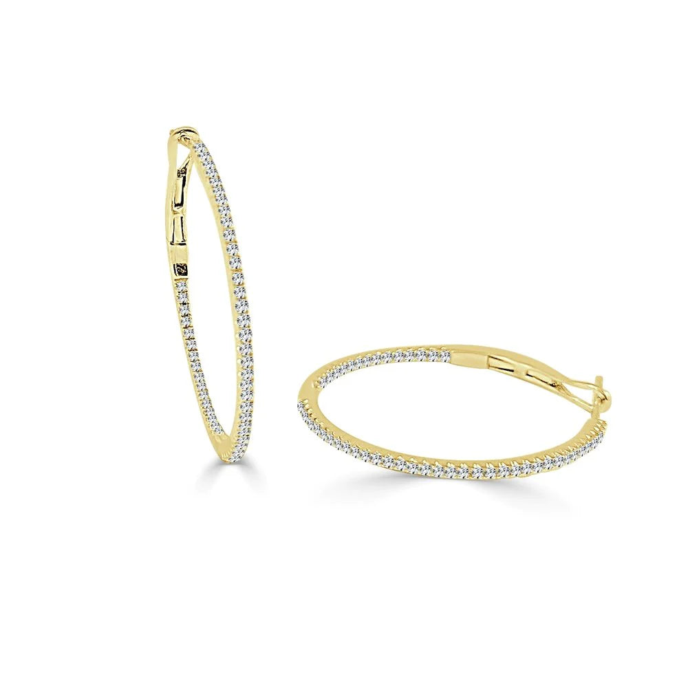 gold hoop earrings with diamonds, one standing up and one laying down 