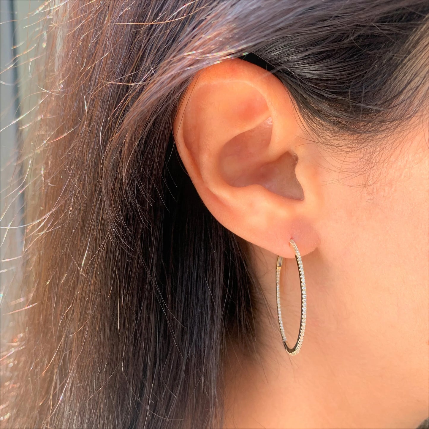 person wearing hoop earring