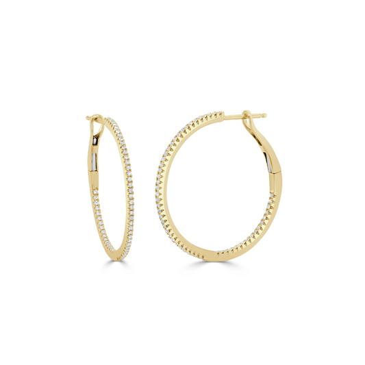 gold hoops with diamonds around it