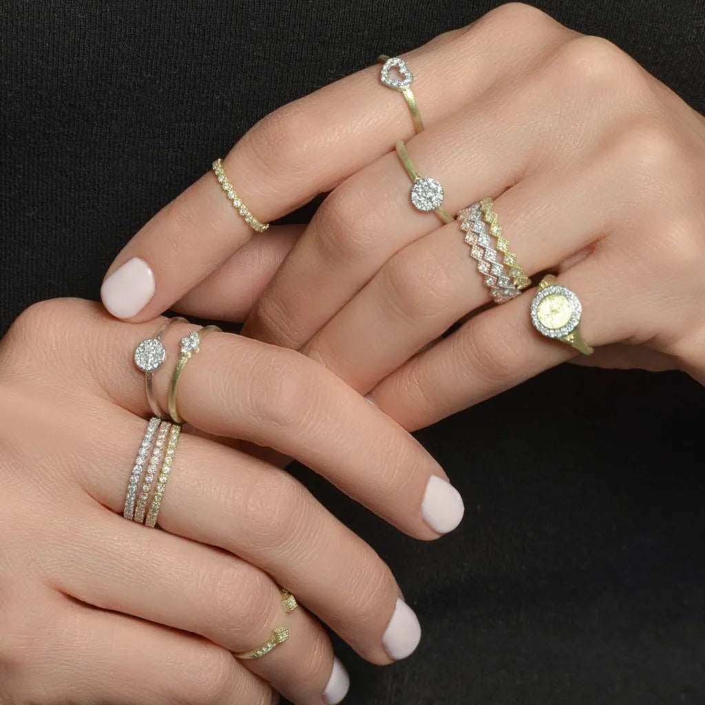 model wearing multiple gold and silver rings with diamonds