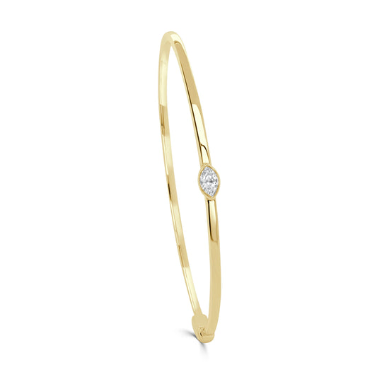 gold bangle with a diamond in the middle