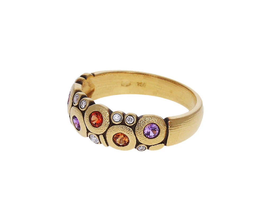 side view of gold ring with colorful gemstones