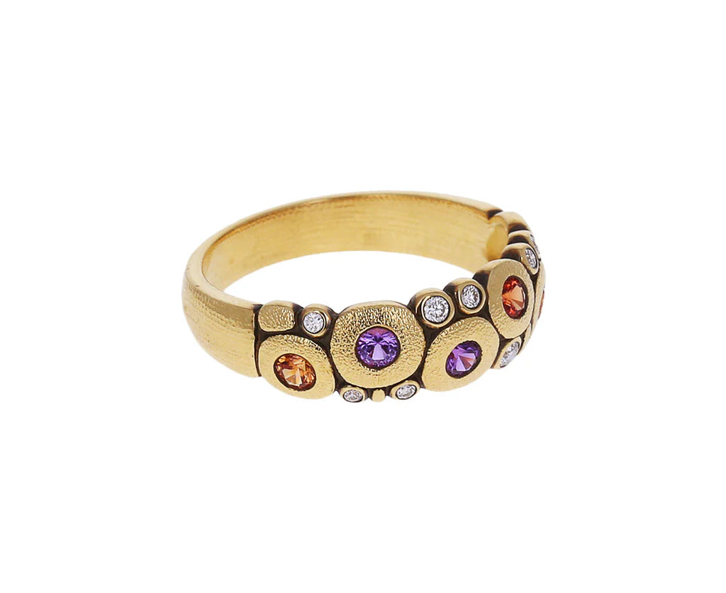 side view of gold ring with colorful gemstones