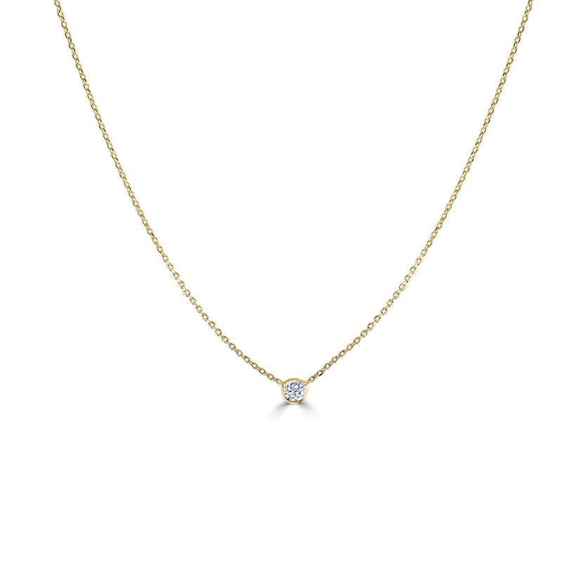 gold necklace with a bezel diamond