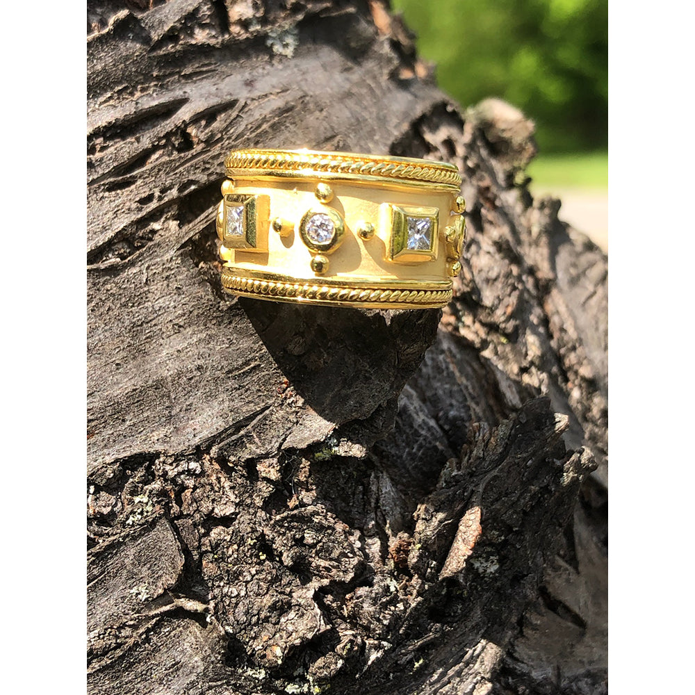 gold band with diamonds on a tree stump