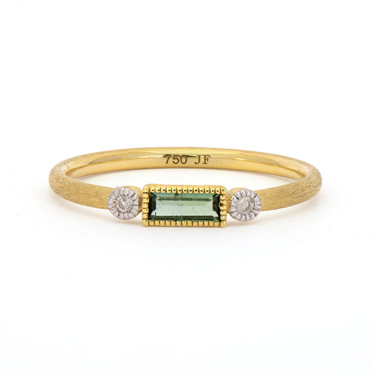 gold band with diamonds on the side of a baguette that is green